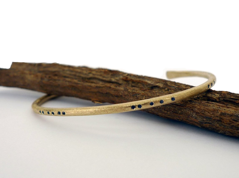 alternative bangle. 14k recycled gold handmade rustic earthy style bracelet. cuff set with blue sapphire. morse code arrangement gold jewelry. fair trade sapphires. 